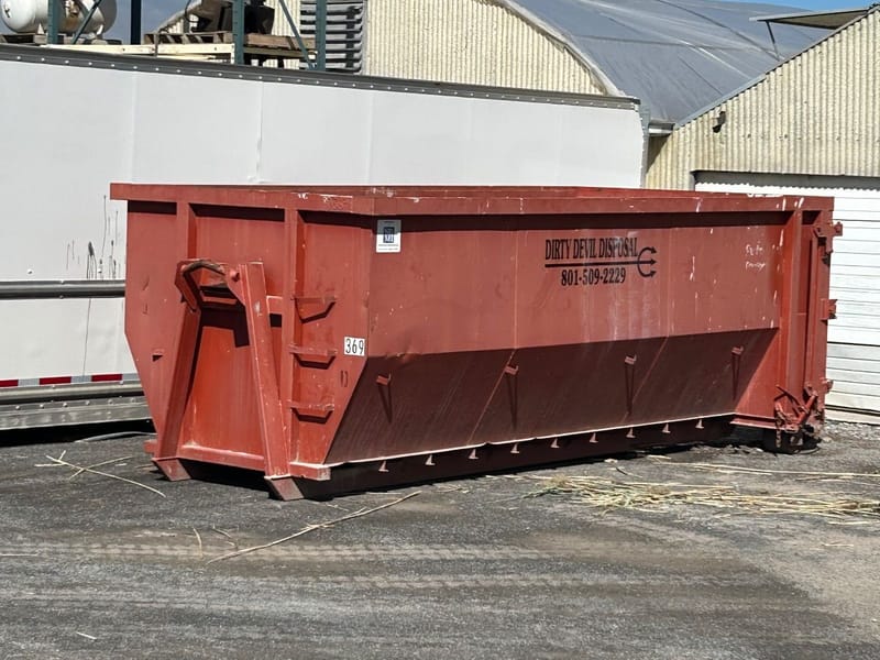 20 yard roll-off dumpster with the Dirty Devil Disposal logo and phone number